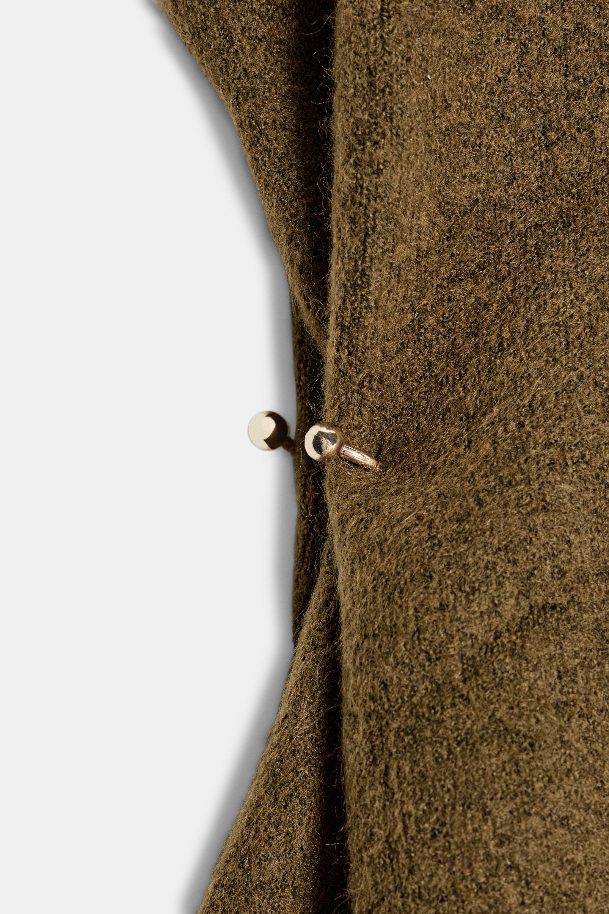 ASYMMETRIC KNIT TOP WITH SIDE APPLIQUÉS